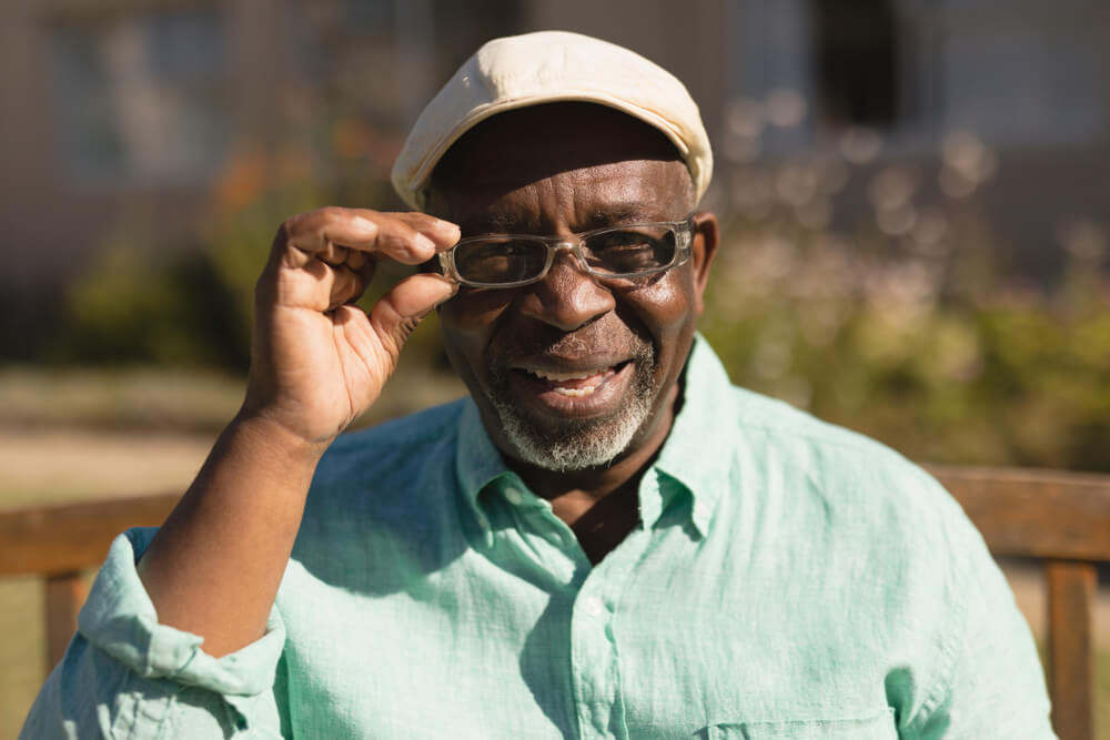 active senior man in spectacle smiling in the park