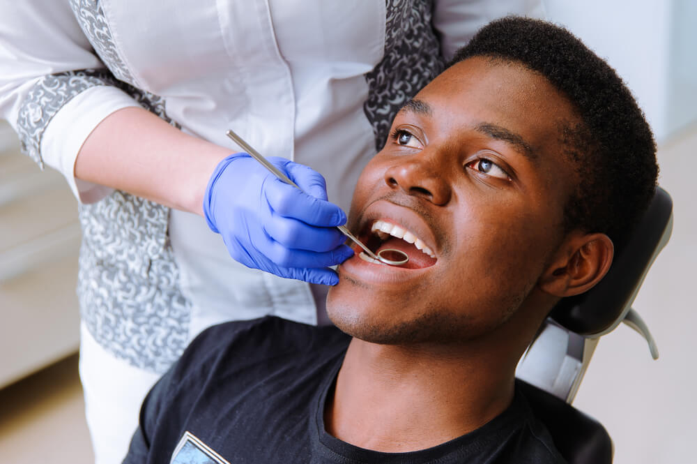 male patient getting dental treatment in dental clinic