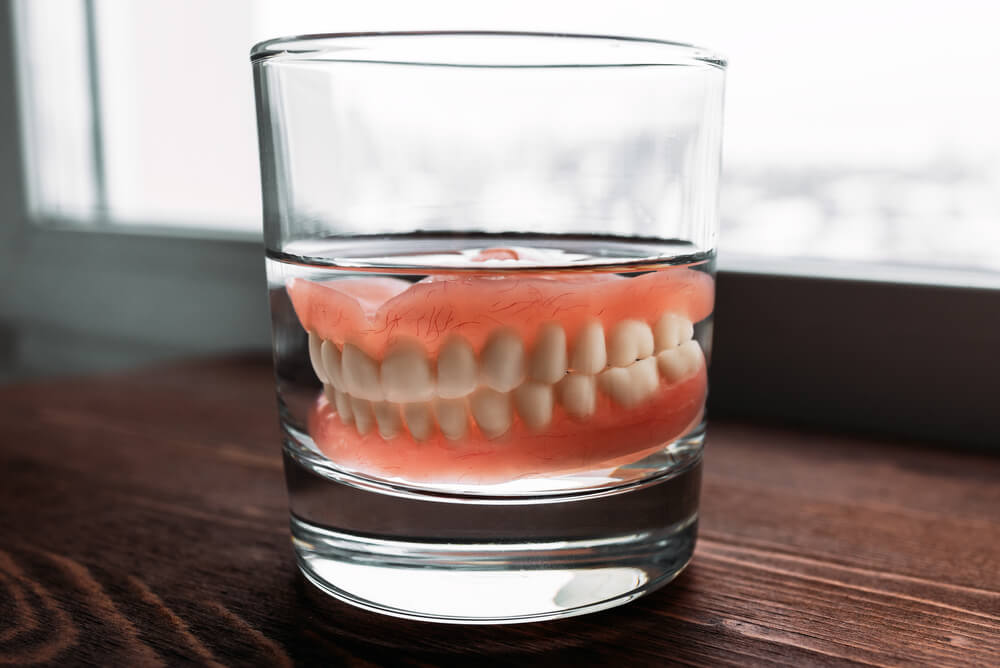 A denture in a glass of water